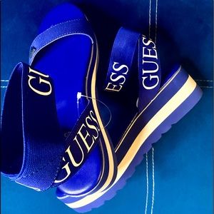 GUESS Crisscross ankle strap sandals in cobalt blue.
